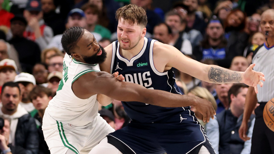 Getty Images - DALLAS, TEXAS - JANUARY 22: Jaylen Brown #7 of the Boston Celtics attempts to steal the ball from Luka Doncic #77 of the Dallas Mavericks in the second half at American Airlines Center on January 22, 2024 in Dallas, Texas. NOTE TO USER: User expressly acknowledges and agrees that, by downloading and or using this photograph, User is consenting to the terms and conditions of the Getty Images License Agreement. (Photo by Tim Heitman/Getty Images)