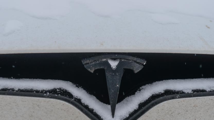 Tesla logo seen on a Tesla car covered with snow in Edmonton. 
On Friday, January 7, 2022, in Edmonton, Alberta, Canada. (Photo by Artur Widak/NurPhoto via Getty Images)