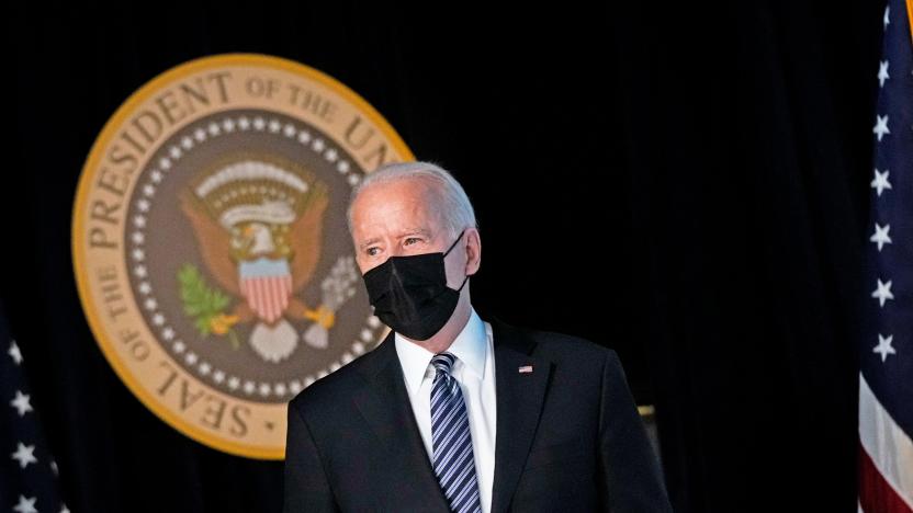 Joseph Biden stands in front of the presidential seal.