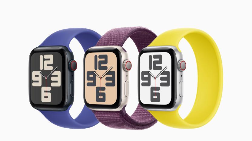 Three second generation Apple Watch SE 2s pictured with a blue, purple and yellow band against a white background