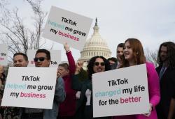 Devotees of TikTok gather at the Capitol in Washington, as the House passed a bill that would lead to a nationwide ban of the popular video app if its China-based owner doesn't sell, Wednesday, March 13, 2024. Lawmakers contend the app's owner, ByteDance, is beholden to the Chinese government, which could demand access to the data of TikTok's consumers in the U.S. (AP Photo/J. Scott Applewhite)