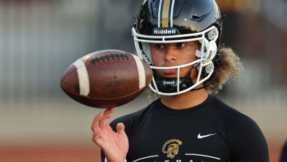 Getty Images - CARROLLTON, GEORGIA - OCTOBER 20:  Julian "Ju Ju" Lewis #10 of the Carrollton High School Trojans warms up prior to facing the Westlake High School Lions at Grisham Stadium on October 20, 2023 in Carrollton, Georgia.  Lewis has committed to the USC Trojans as a 15-year-old Carrollton High School student and is considered one of the top high school quarterback prospects.  (Photo by Kevin C. Cox/Getty Images)