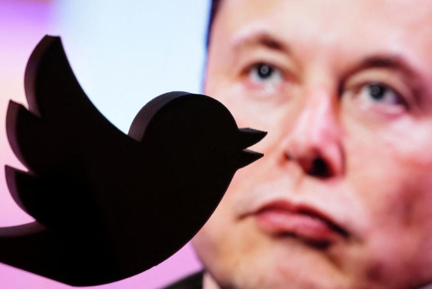 A 3D printed Twitter logo is seen in front of a displayed photo of Elon Musk in this illustration taken October 27, 2022. REUTERS/Dado Ruvic/Illustration