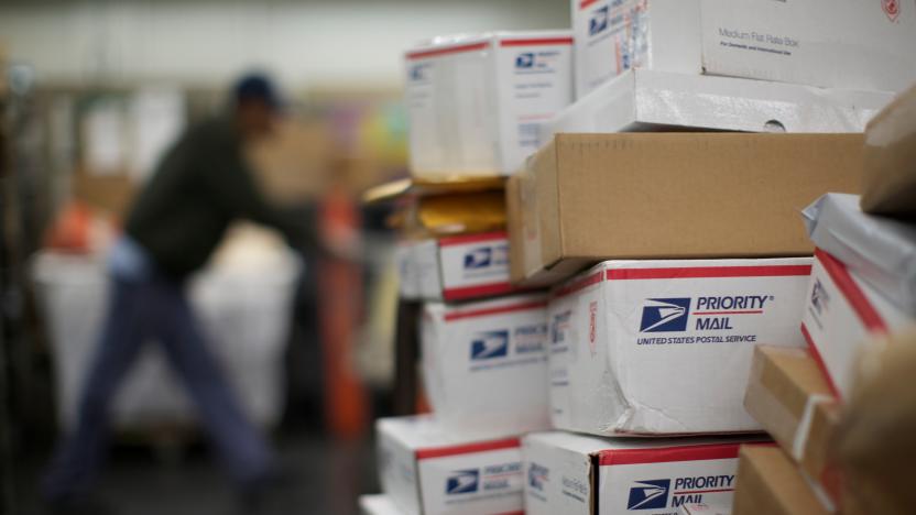 United States Postal Service (USPS) mail clerks sort packages at the Lincoln Park carriers annex in Chicago, November 29, 2012. The USPS, which relies on the sale of stamps and other products rather than taxpayer dollars, has been grappling for years with high costs and tumbling mail volumes as consumers communicate more online.  REUTERS/John Gress (UNITED STATES - Tags: BUSINESS SOCIETY EMPLOYMENT)