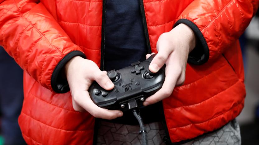 An attendee uses a Nintendo Switch game console while playing a video game at the Paris Games Week (PGW), a trade fair for video games in Paris, France, October 29, 2019. REUTERS/Benoit Tessier