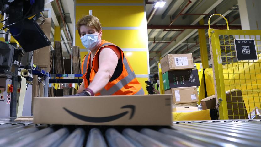 An employee prepares a package for shipment at the Amazon logistics centre in Suelzetal near Magdeburg, eastern Germany, on Mai 12, 2021. - The US online sales giant had opened the new warehouse in Saxony-Anhalt in August 2020. (Photo by Ronny Hartmann / AFP) (Photo by RONNY HARTMANN/AFP via Getty Images)