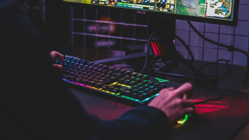 A person uses a keyboard and mouse to play a PC game.