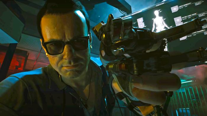 A closeup shot of Viktor Vektor in the video game Cyberpunk 2077, seemingly as he hovers over your own POV to do some cyber upgrades on you.