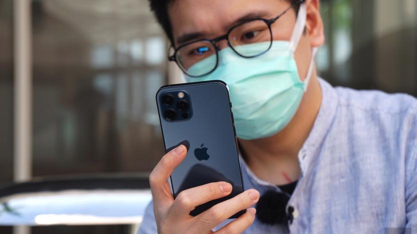 An iPhone 13 Pro user wearing a surgical mask.