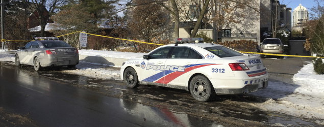 Police cars are parked outside the home of billionaire Barry Sherman in Toronto. (AP)