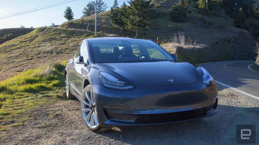 Tesla EV on the side of a road.