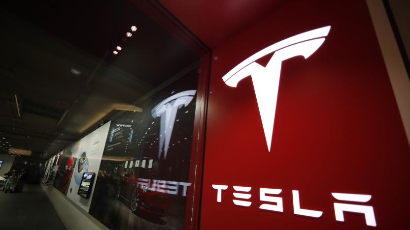 FILE - A sign bearing the company logo outside a Tesla store in Cherry Creek Mall in Denver is seen here on Feb. 9, 2019. Tesla is recalling nearly 363,000 vehicles with its “Full Self-Driving” system to fix problems with the way it behaves around intersections and following posted speed limits, the National Highway Traffic Safety Administration announced Thursday, Feb. 16, 2023. (AP Photo/David Zalubowski, File)