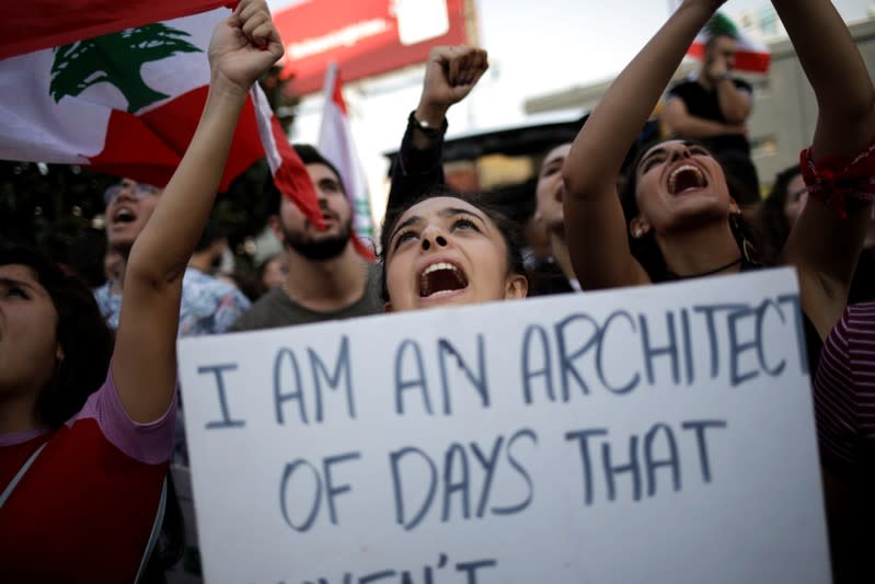 Demonstrators shout slogans outside of Alfa headquarters during a protest in Beirut