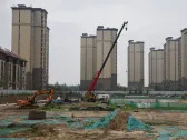 China's state-owned developers dominate sales, land markets in 2023 - surveys