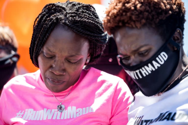 Wanda Cooper-Jones (L), Ahmaud Arbery&#39;s mother, and his sister Jasmine Arbery (R) comfort one another at a rally after the first two suspects were arrested in the young man&#39;s fatal shooting in the state of Georgia -- a death that has sparked outrage