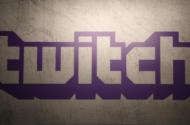 FILE - The logo of live streaming video platform Twitch is shown at the Paris games week in Paris, Saturday, Nov. 4, 2017. The shooting in Buffalo has put a spotlight on how social media companies are monitoring content that appears on their platforms. The suspected gunman shot 11 Black and two white victims in an attack that was shared on the live-streaming platform Twitch, echoing a deadly attack in a German synagogue broadcast on the platform in October 2019. (AP Photo/Christophe Ena, File)