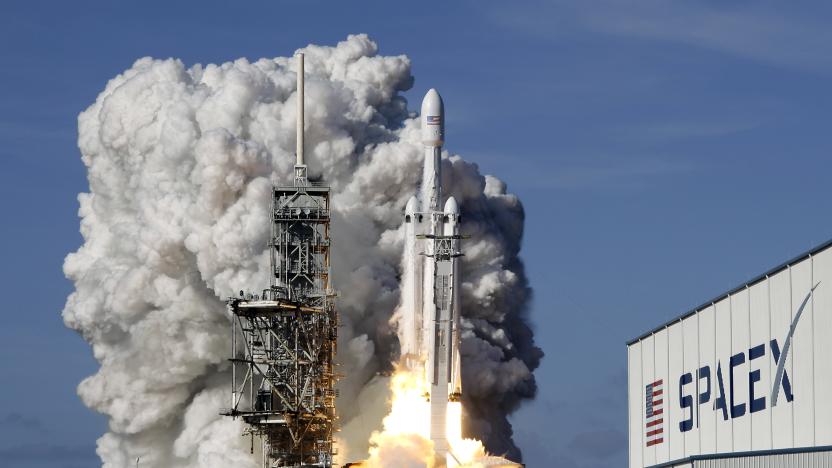 A Falcon 9 SpaceX heavy rocket lifts off from pad 39A at the Kennedy Space Center in Cape Canaveral, Fla., Tuesday, Feb. 6, 2018. The Falcon Heavy, has three first-stage boosters, strapped together with 27 engines in all. (AP Photo/John Raoux)