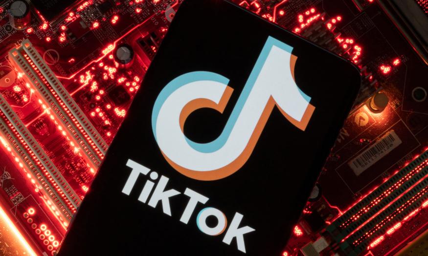 A smartphone with a displayed TikTok logo is placed on a computer motherboard in this illustration taken February 23, 2023. REUTERS/Dado Ruvic/Illustration