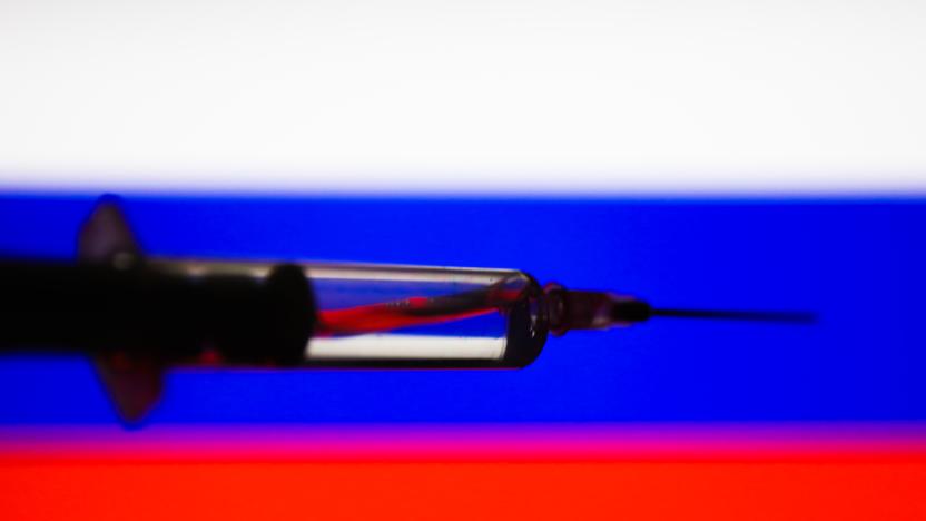 In this illustration photo a medical syringe is seen with Russian flag in the background. Picture taken in Krakow, Poland, on August 11, 2020. President of Russia Vladimir Putin announced that Russia has registered the first covid-19 vaccine. (Photo by Jakub Porzycki/NurPhoto via Getty Images)