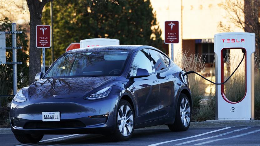 A Tesla electric vehicle is seen at a Tesla electric vehicle charging station at Willow Festival shopping plaza parking lot in Northbrook, Ill., Saturday, Dec. 3, 2022. (AP Photo/Nam Y. Huh)