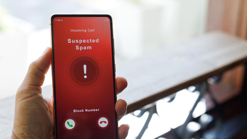 A man receiving an incoming suspected spam call on her phone. The network provider detect the scam and show warning sign to rejects the call.