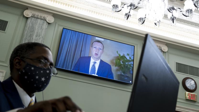 WASHINGTON, DC - OCTOBER 28: CEO of Facebook Mark Zuckerberg appears on a monitor behind a stenographer as he testifies remotely during the Senate Commerce, Science, and Transportation Committee hearing 'Does Section 230's Sweeping Immunity Enable Big Tech Bad Behavior?', on Capitol Hill, October 28, 2020 in Washington, DC. CEO of Twitter Jack Dorsey; CEO of Alphabet Inc. and its subsidiary Google LLC, Sundar Pichai; and CEO of Facebook Mark Zuckerberg all testified virtually at the hearing. Section 230 of the Communications Decency Act guarantees that tech companies can not be sued for content on their platforms, but the Justice Department has suggested limiting this legislation. (Photo by Michael Reynolds-Pool/Getty Images)