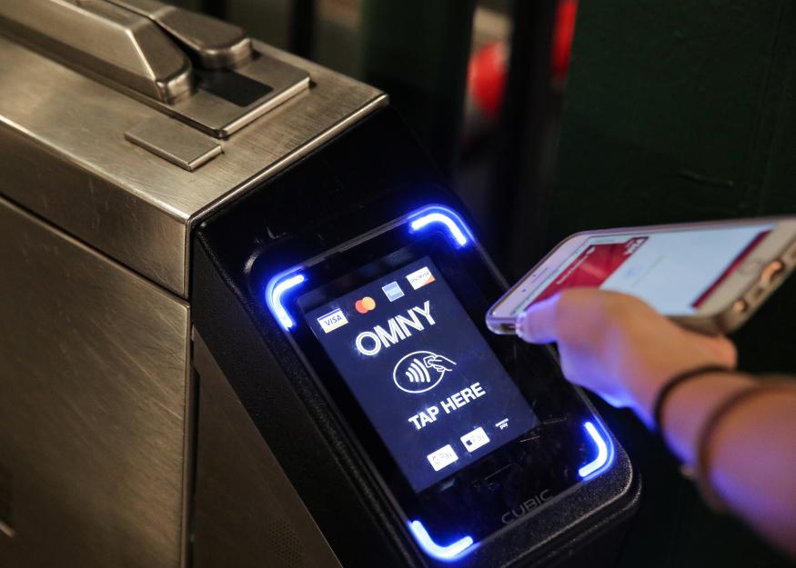 A customer uses a phone to pay for a New York City subway ride on the first day of operation of the OMNY (One Metro NY) contactless payment system in New York, U.S., May 31, 2019. REUTERS/Brendan McDermid