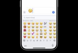 The thinking face emoji is shown in a text field above the iPhone emoji keyboard