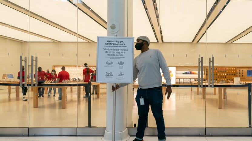 NEW YORK, NY - DECEMBER 28: An employee puts out a sign with Covid-19 guidelines at an Apple store on December 28, 2021 in New York City. Apple closed 11 of its retail locations in New York City in response to the rise in COVID-19 cases. (Photo by David Dee Delgado/Getty Images)