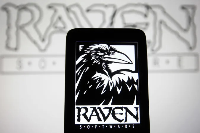 UKRAINE - 2022/01/26: In this photo illustration, a Raven Software Corporation logo of a video game developer is seen on a smartphone and a computer screen. (Photo Illustration by Pavlo Gonchar/SOPA Images/LightRocket via Getty Images)