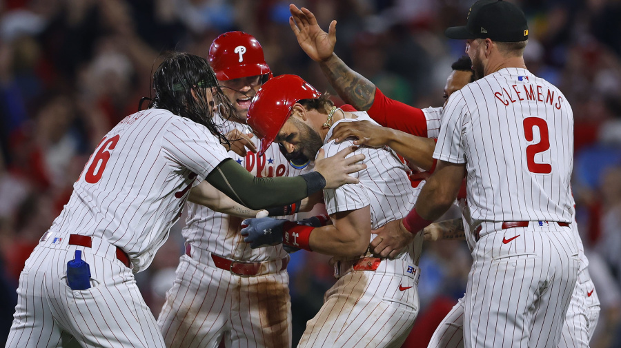 Getty Images - PHILADELPHIA, PENNSYLVANIA - MAY 18: Bryce Harper #3 of the Philadelphia Phillies is mobbed by teammates after he hit a sacrifice fly in the 10th inning to score the winning run against the Washington Nationals during a game at Citizens Bank Park on May 18, 2024 in Philadelphia, Pennsylvania. The Phillies defeated the Nationals 4-3 in 10 innings. (Photo by Rich Schultz/Getty Images)