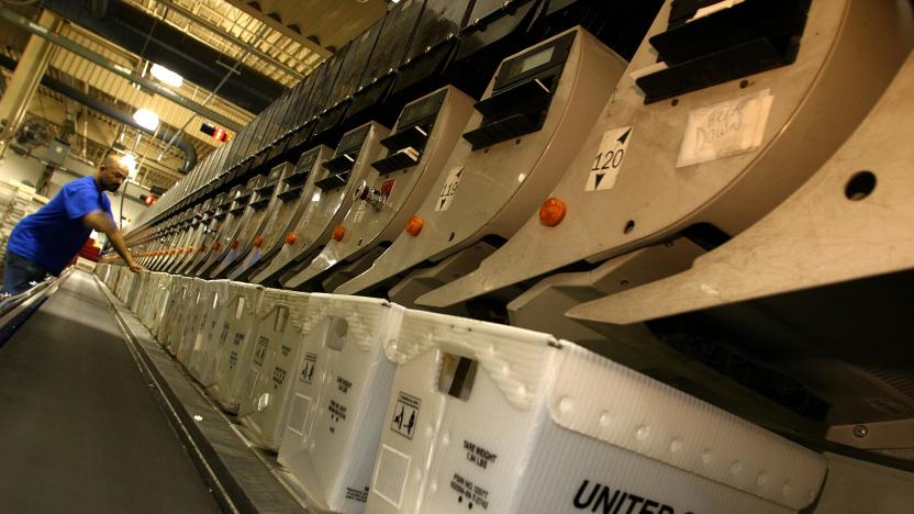 CAPITOL HEIGHTS, UNITED STATES:  A postal employee attends to an automated sorting machine at the United States Postal Service's processing and distribution center in Capitol Heights, Maryland, 19 December 2002.  The processing and distribution center, which operates 24-hours a day, expects to handle some 800,000 pieces of mail 19 December 2002, two times the normal amount, as Christmas approaches. AFP PHOTO / Robyn BECK (Photo credit should read ROBYN BECK/AFP via Getty Images)