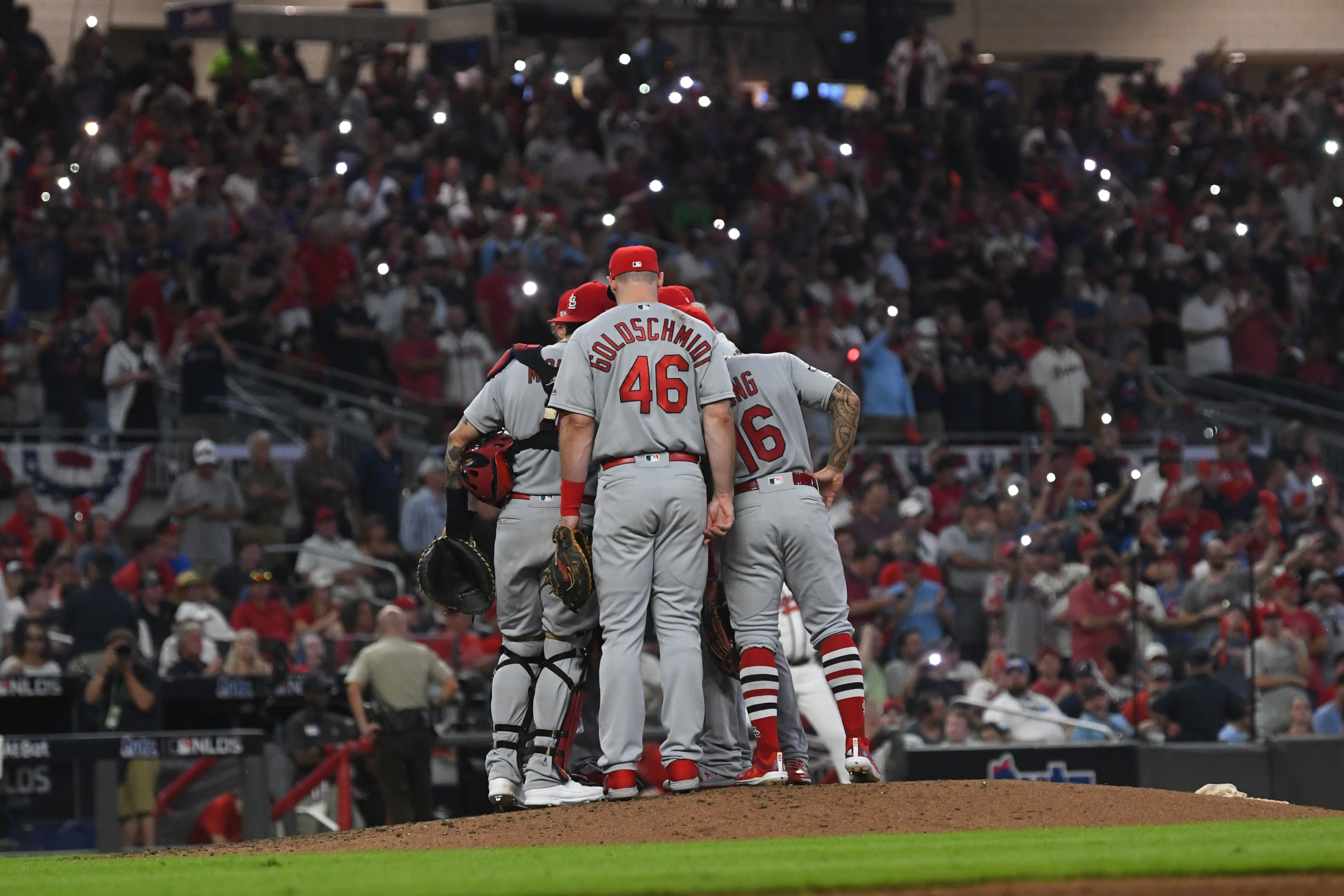 Cardinals score 4 in 9th, hold off Braves 7-6 in NLDS opener