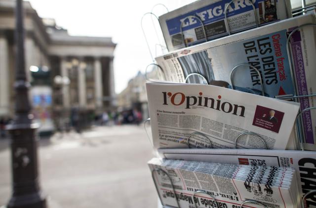 A copy of the newspaper "L'opinion" is pictured in a newsstand on May 15, 2013 in Paris. The newspaper, also available online, was released on May 15, 2013 in France. AFP PHOTO/FRED DUFOUR        (Photo credit should read FRED DUFOUR/AFP via Getty Images)