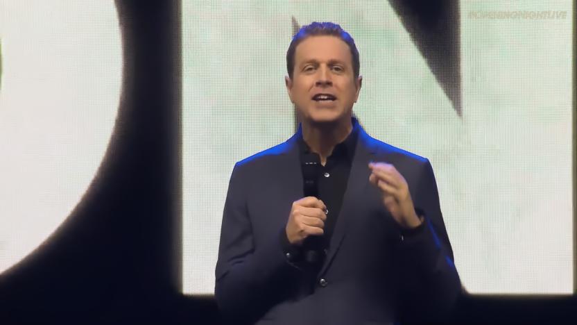 Host Geoff Keighley onstage at the 2023 Gamescom Opening Night Live. Gesturing excitedly while looking into the camera and holding a mic.