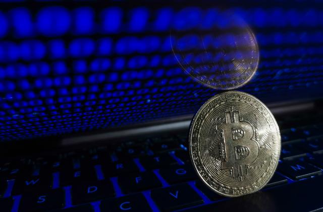 Representation of Bitcoin is seen with binary code displayed on a laptop screen in this illustration photo taken in Krakow, Poland on August 17, 2021. (Photo by Jakub Porzycki/NurPhoto via Getty Images)