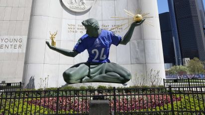 Associated Press - An NFL football draft jersey is displayed on the Spirit of Detroit statue Friday, April 19, 2024, in Detroit. The draft has taken the show on the road for a decade, giving cities a chance around the country a chance to be in the spotlight. The Motor City, which was once one of the nation's largest and most powerful cities, has bounced back from filing for bankruptcy in 2013. (AP Photo/Carlos Osorio)