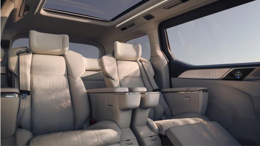 Volvo EM90 interior, showing large windows and sunroof, along with theater-style seats with footrests .