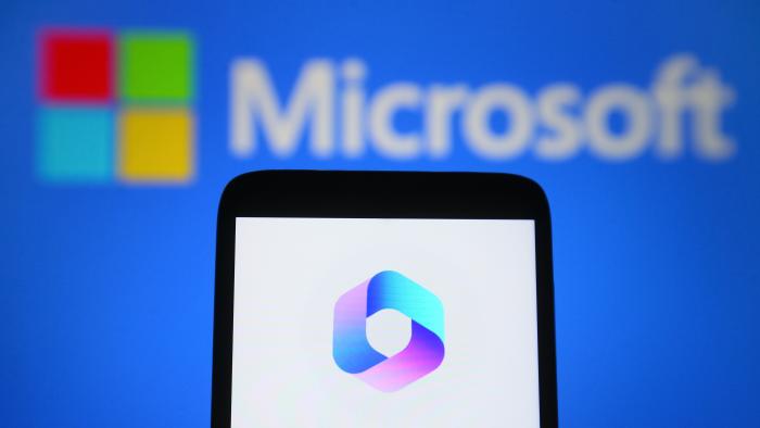 UKRAINE - 2023/03/17: In this photo illustration, a Microsoft 365 Copilot logo is seen on a smartphone and Microsoft logo on the background. (Photo Illustration by Pavlo Gonchar/SOPA Images/LightRocket via Getty Images)