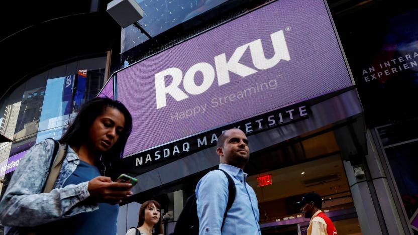 People pass by a video sign display with the logo for Roku Inc, a Fox-backed video streaming firm, that held it's IPO at the Nasdaq Marketsite in New York, U.S., September 28, 2017. REUTERS/Brendan McDermid