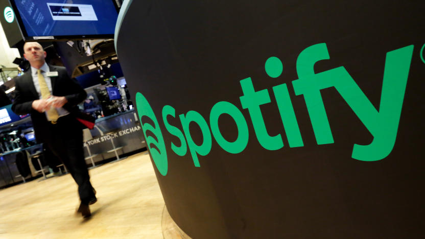 FILE - A trading post sports the Spotify logo on the floor of the New York Stock Exchange, Tuesday, April 3, 2018. Spotify said Monday, Dec. 4, 2023 it's axing 17% of its global workforce, in the music streaming service's third round of layoffs this year as it tries to slash costs while focusing on profitabilty. (AP Photo/Richard Drew, File)