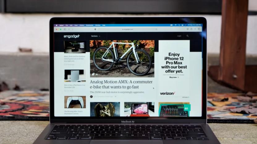 A laptop on a desk, open showing Engadget.