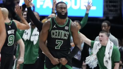 Associated Press - Boston Celtics guard Jaylen Brown (7) and the Celtics bench react after forward Jayson Tatum made a 3-point basket at the buzzer to end the first half of an NBA basketball game against the New Orleans Pelicans in New Orleans, Saturday, March 30, 2024. (AP Photo/Gerald Herbert)
