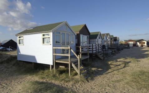 Picture shows a row of luxury beach huts on Mudeford Spit in Dorset - Credit: Geoff Pugh