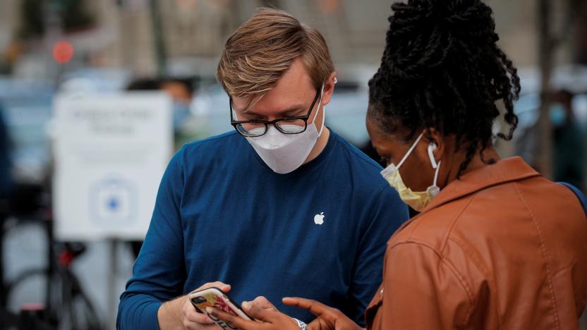 A customers speaks to an employee outside an Apple Store to pick up Apple's new 5G iPhone 12, as the coronavirus disease (COVID-19) outbreak continues in Brooklyn, New York, U.S. October 23, 2020.  REUTERS/Brendan McDermid