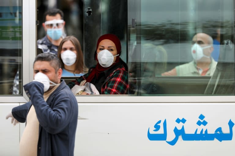 Lebanese nationals returned from Saudi Arabia board buses upon their arrival at the Beirut international airport (AFP Photo/ANWAR AMRO)