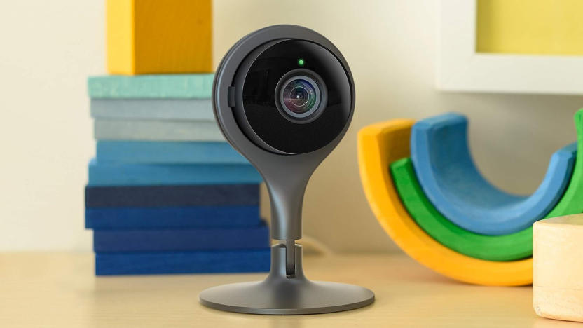 A security camera on top of a table with blocks in the background.