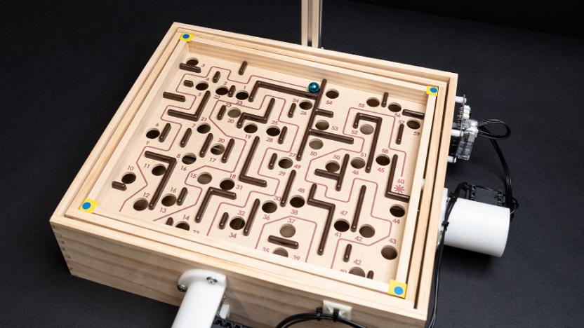 The marble game Labyrinth with motors atached to the dials.
