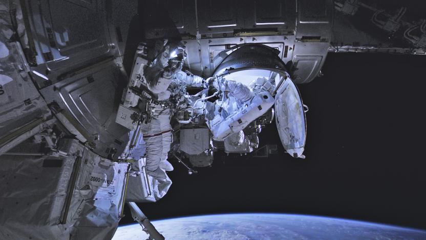 A still from the final installment of the 'Space Explorers: The ISS Experience' showing two astronauts outside of the ISS.