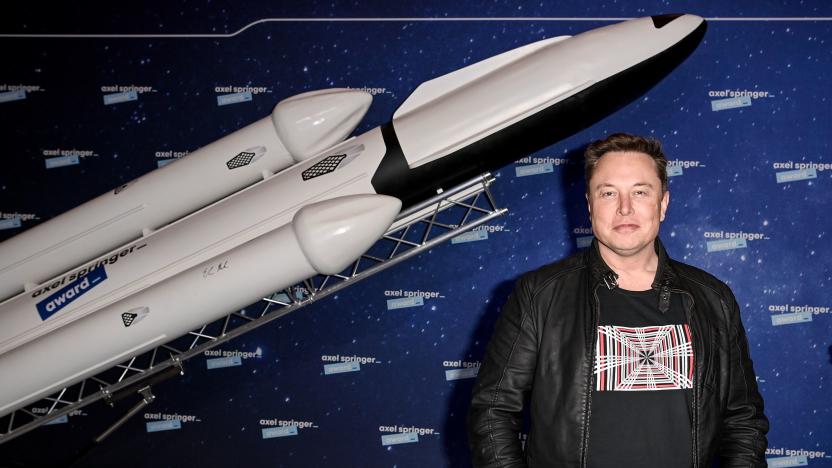 SpaceX owner and Tesla CEO Elon Musk (R) gestures as he arrives on the red carpet for the Axel Springer Awards ceremony, in Berlin, on December 1, 2020. (Photo by Britta Pedersen / POOL / AFP) (Photo by BRITTA PEDERSEN/POOL/AFP via Getty Images)